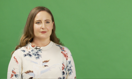 Presenter for video shoot in front of green screen in studio