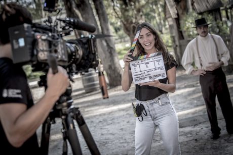 girl on film set after graduating from film school being filmed by video camera
