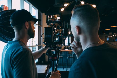 two crew members on a video production job after graduating